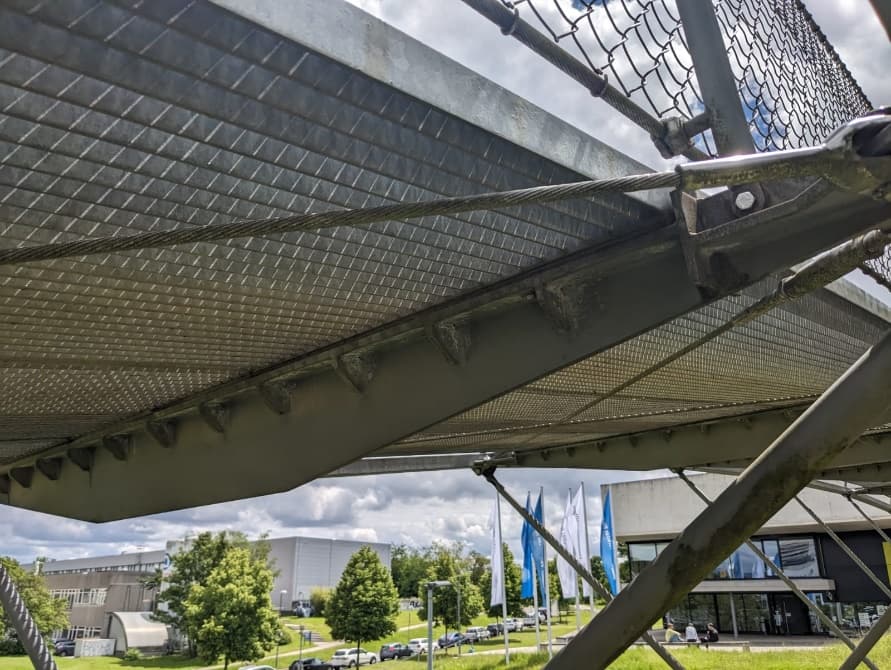 Close-up of the bridge deck underside showing cross-girders and cable connections